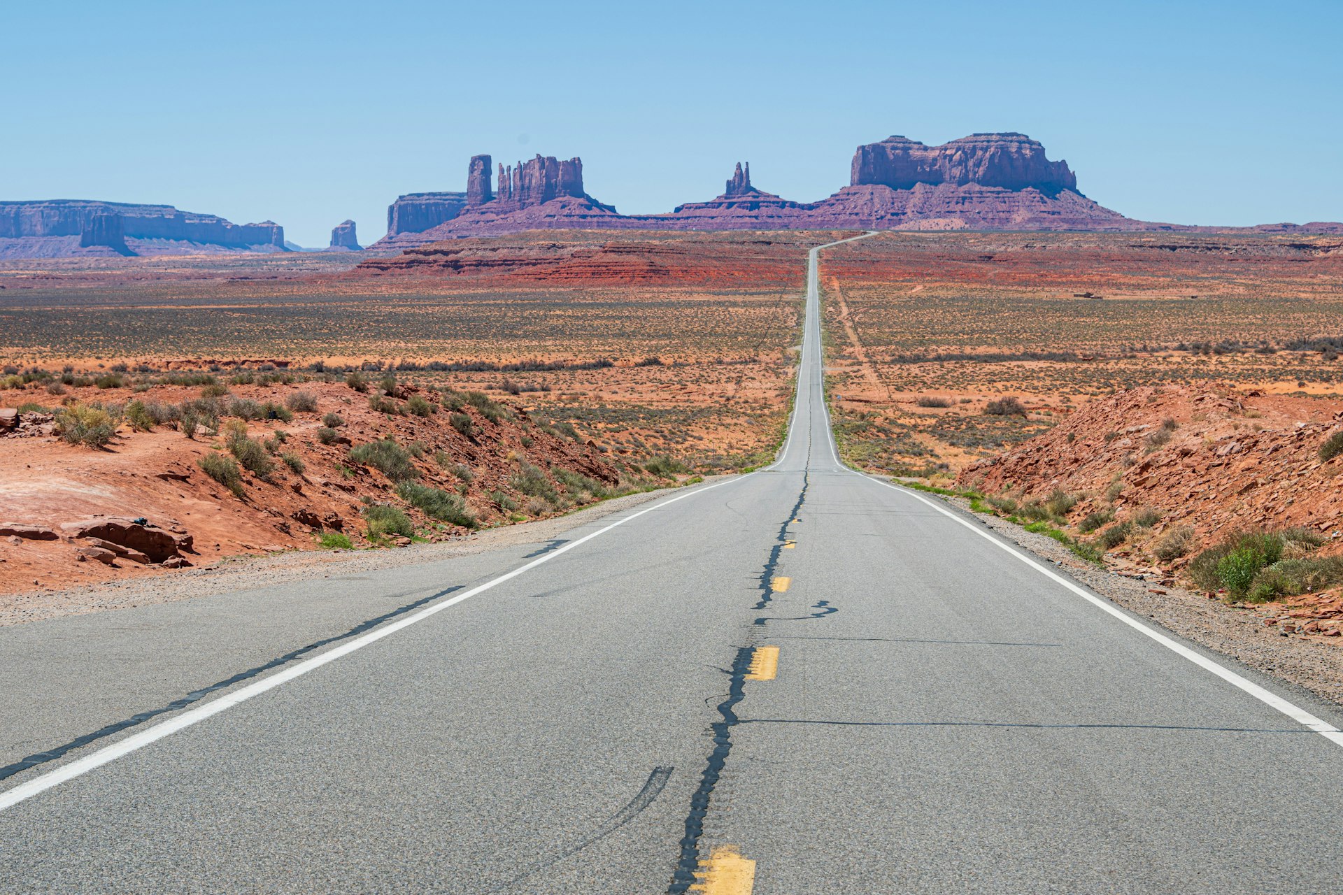 a long straight road in the middle of the desert